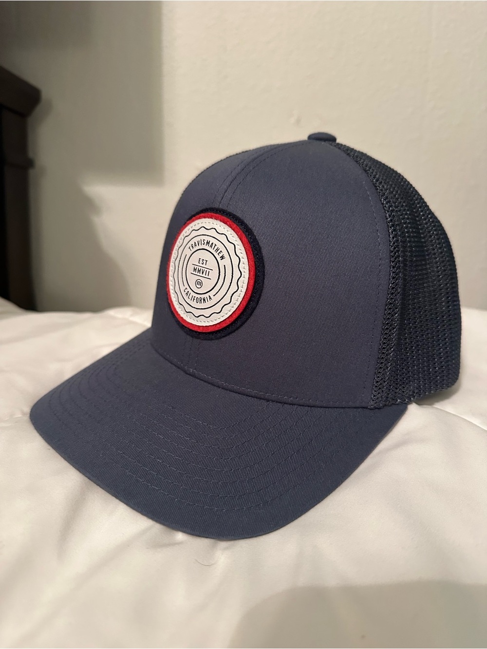 Travis Mathew Navy Mesh Back Trucker Hat with Red-Trim Patch